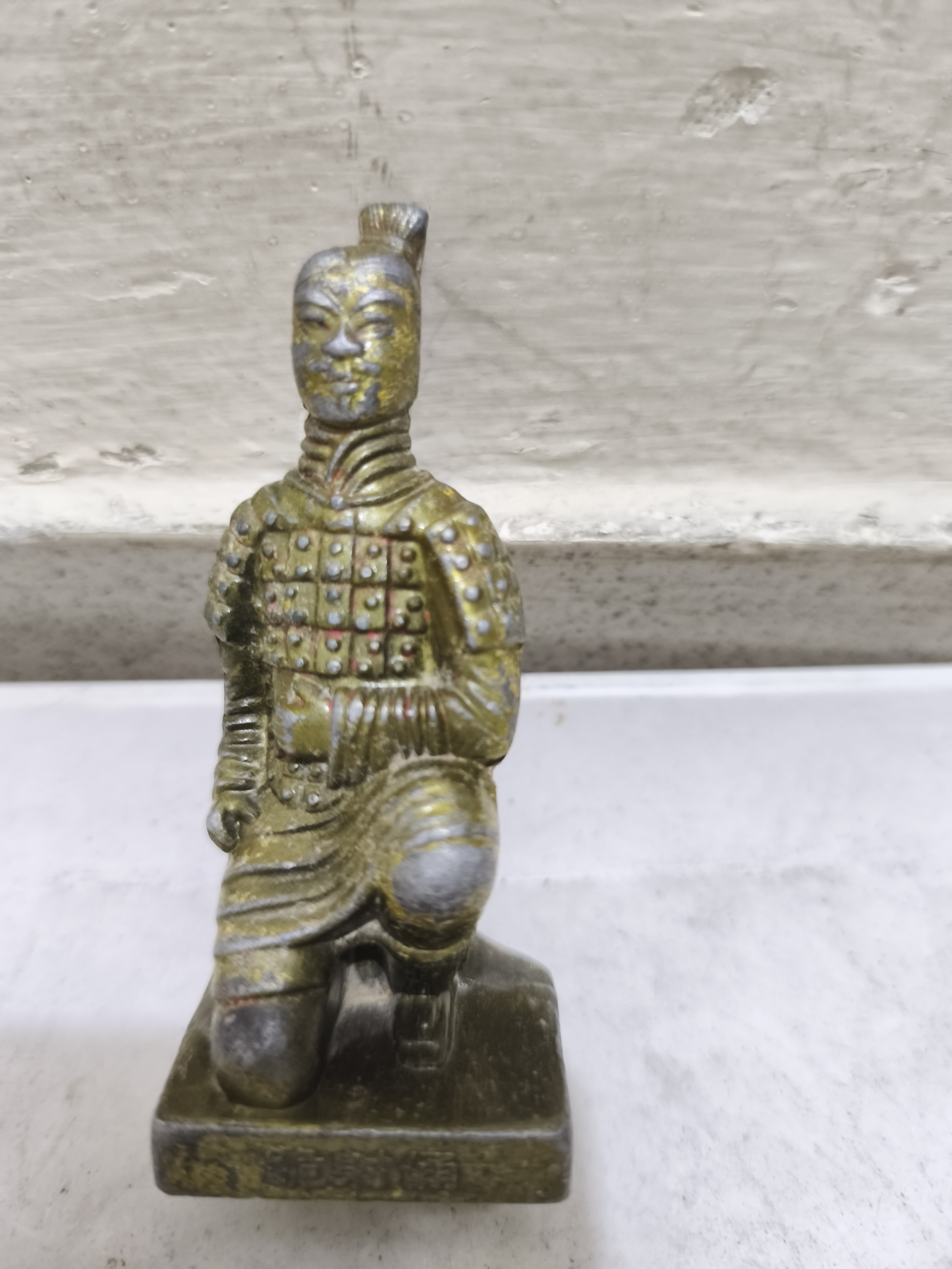 একজন চীনা টেরাকোটা যোদ্ধার একটি আলংকারিক ক্ষুদ্র প্রতিরূপ